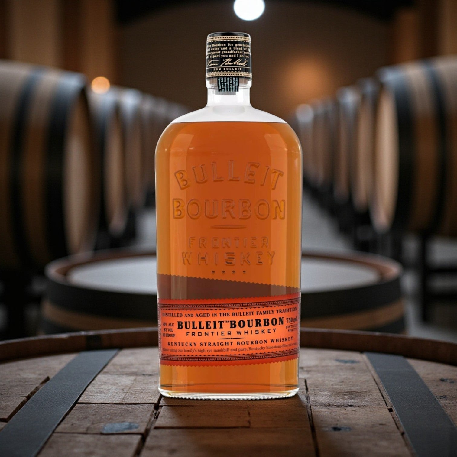 Bulleit Bourbon Frontier Whiskey 750ml bottle on wooden bar with warm lighting – lifestyle image from Total Bourbon