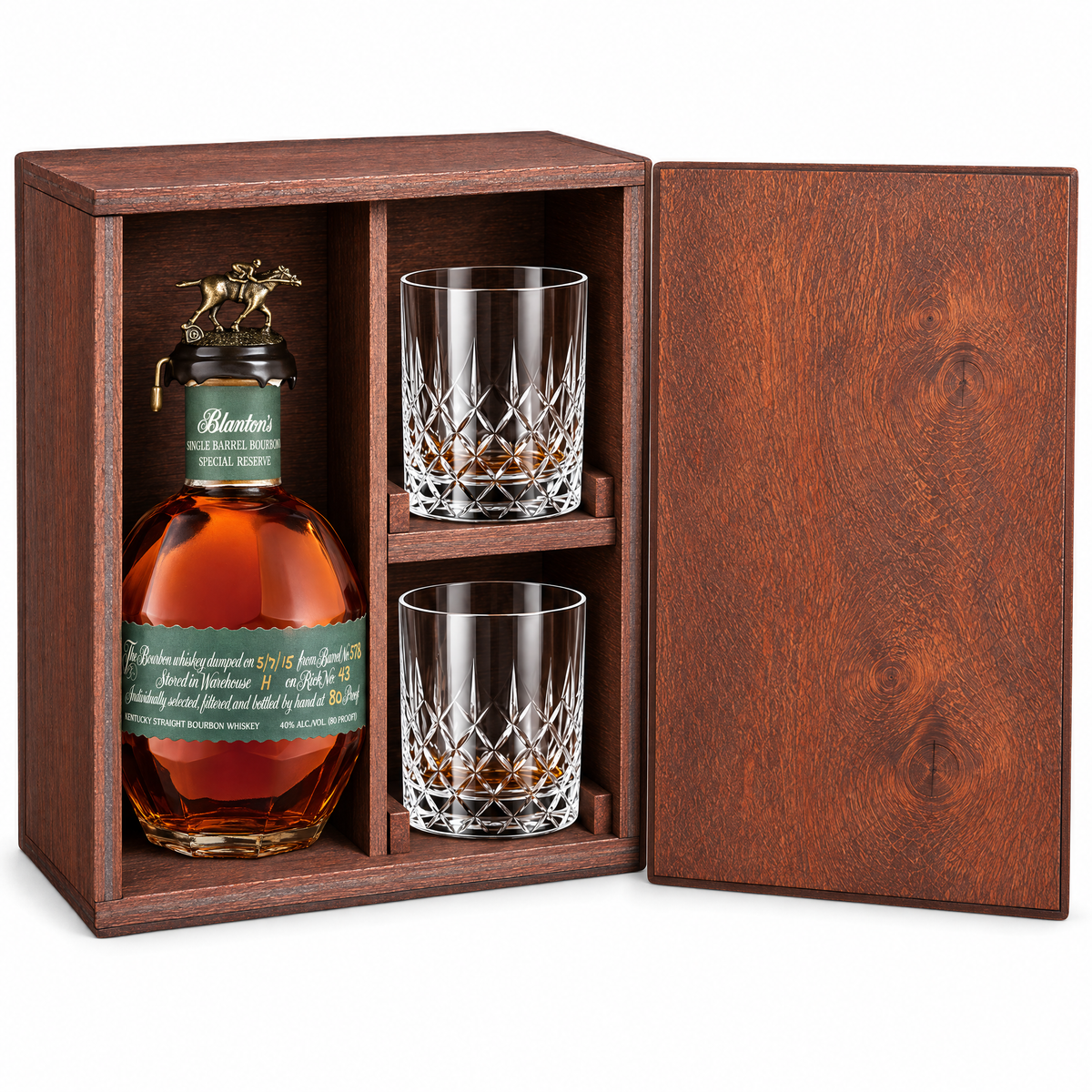 A wooden gift box with a bottle of Blanton's whiskey and two cut-glass tumblers, shown on a clean white background with the front door open.