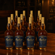 W.L. Weller Full Proof 114-proof wheated Kentucky straight bourbon — 12-bottle case, navy-and-gold labels, dark private-vault setting