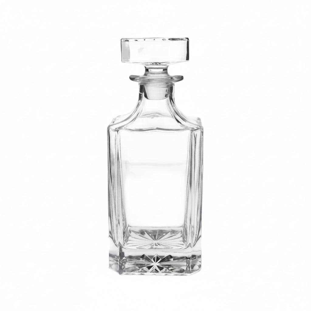 Clear glass decanter on a beige background