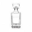 Clear glass decanter on a beige background