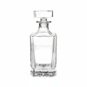 Clear glass decanter on a beige background