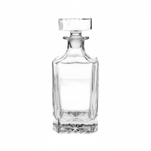 Clear glass decanter on a beige background