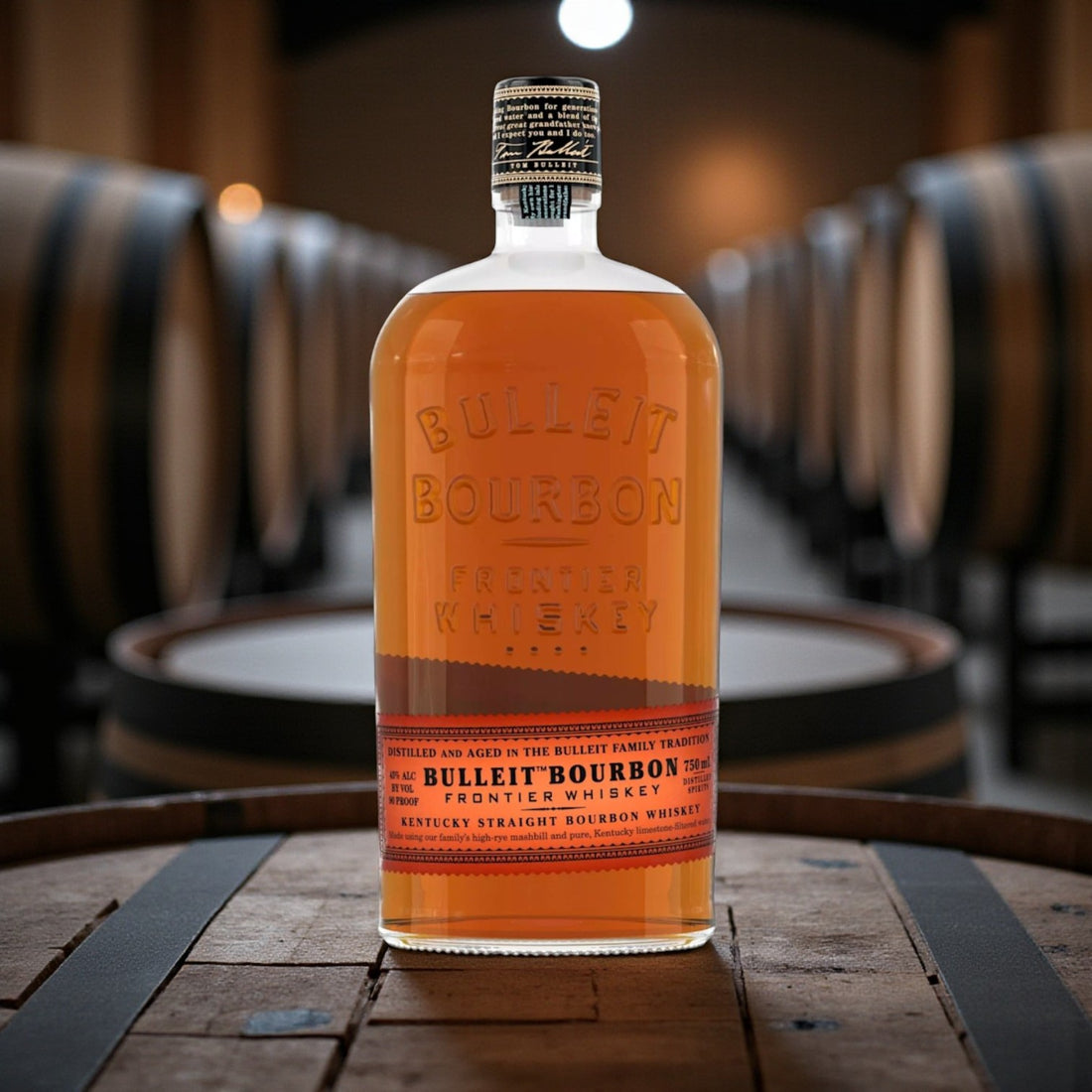 Bulleit Bourbon Frontier Whiskey 750ml bottle on wooden bar with warm lighting – lifestyle image from Total Bourbon