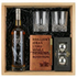 Eagle Rare 12 Year Old Kentucky Straight Bourbon Whiskey gift crate with crystal whiskey glasses, leather bourbon journal with brass pen, and stainless steel whiskey balls on black crinkle paper fill