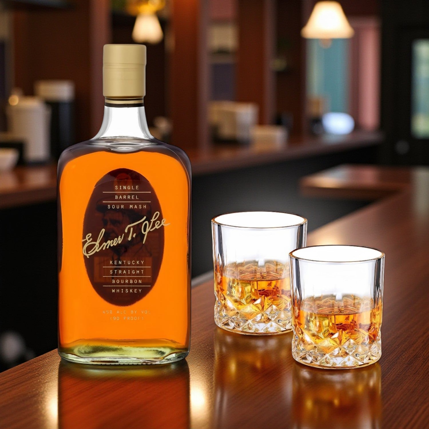 Elmer T. Lee Single Barrel Bourbon 750ml bottle with two old-fashioned glasses on a polished bar – premium bourbon gift set photographed for Total Bourbon