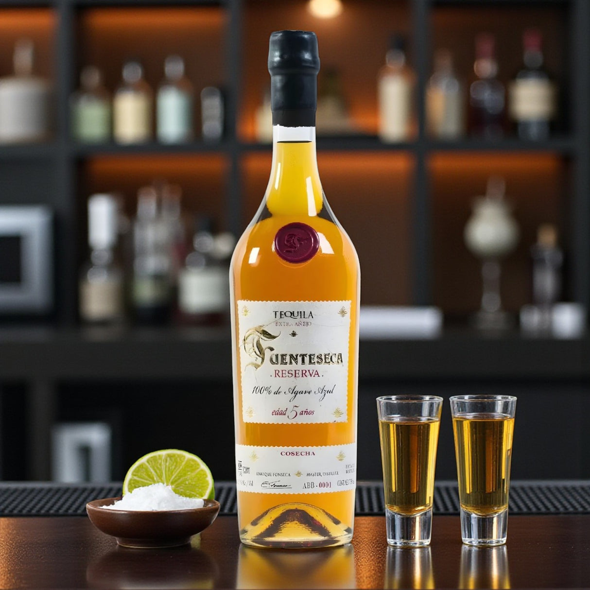 Fuenteseca Reserva 5 Year Extra Añejo Tequila Limited Edition bottle on bar with shot glasses, lime, and salt – lifestyle photo from Total Bourbon