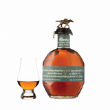 Blanton's Green Special Reserve single barrel bourbon bottle beside a Glencairn tasting glass on white