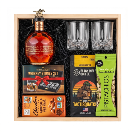 Blanton's Gold Edition bourbon gift crate with two crystal-cut glasses, whiskey stones, ground coffee, dark chocolate, and pistachios nested in a natural wood crate.