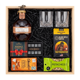 Blanton's Straight From the Barrel bourbon gift crate with two crystal-cut glasses, whiskey stones, ground coffee, dark chocolate, and pistachios in a natural wood crate.