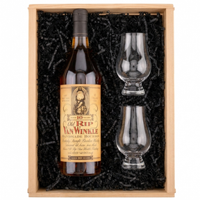 A whiskey gift set in a light wood box filled with black crinkle paper. The set includes a bottle of Van Winkle 10 Year Old rye whiskey with a tan label, and two clear crystal tasting glasses.