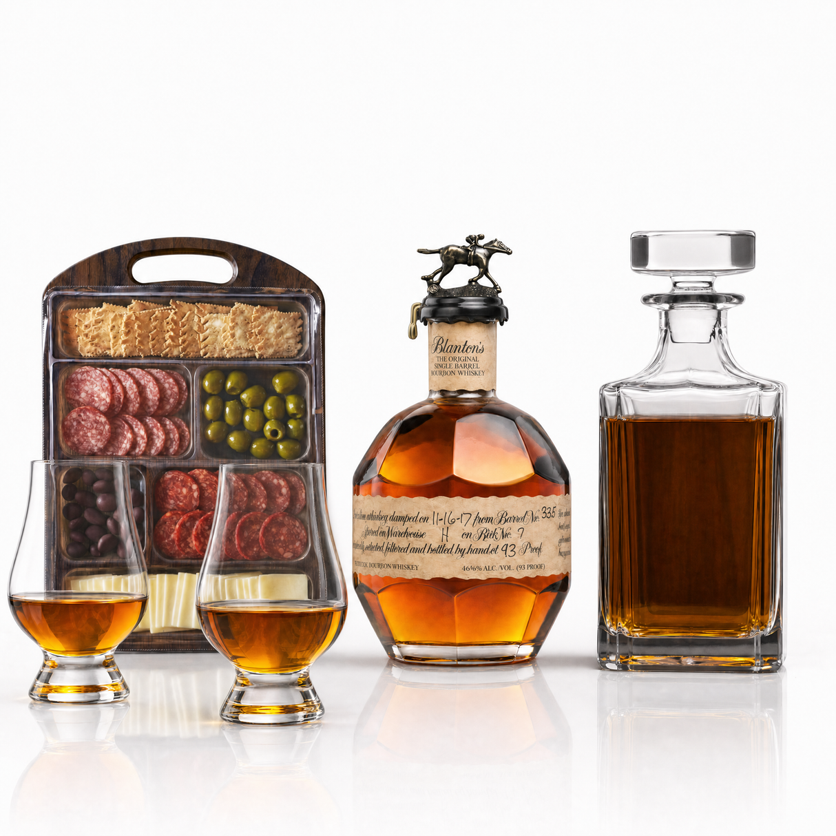 Blanton's Single Barrel 750ml bottle with two Glencairn glasses, a glass decanter, and a charcuterie board kit