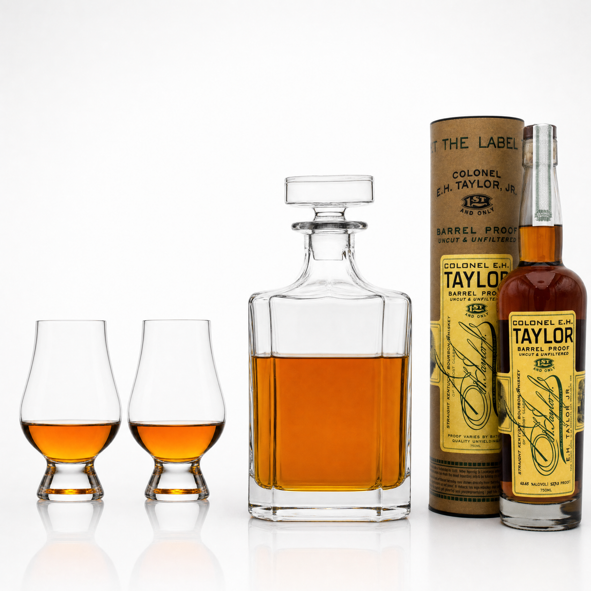 E.H. Taylor Barrel Proof 750ml bottle with two Glencairn glasses and a glass decanter, part of the E.H. Taylor Barrel Proof Value Bundle