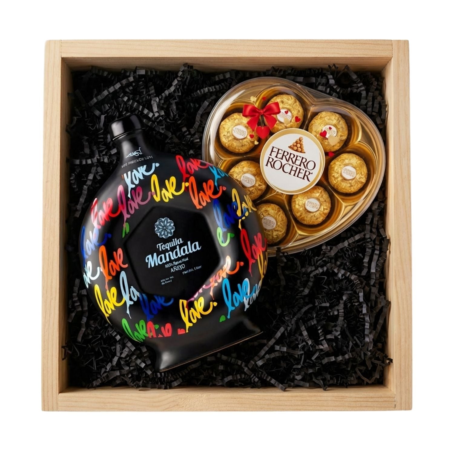 Mándala Love Añejo Tequila gift crate with black ceramic decanter featuring colorful love script and heart-shaped Ferrero Rocher hazelnut chocolate box in natural wood crate with black crinkle fill, romantic gift