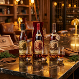 Pappy Van Winkle "Top Shelf Trio" Collection featuring Family Reserve 15 Year, 20 Year with red velvet bag, and 23 Year Limited Edition Kentucky Straight Bourbon Whiskey bottles displayed in an upscale whiskey lounge setting with crystal glassware – 750ml collector's bundle