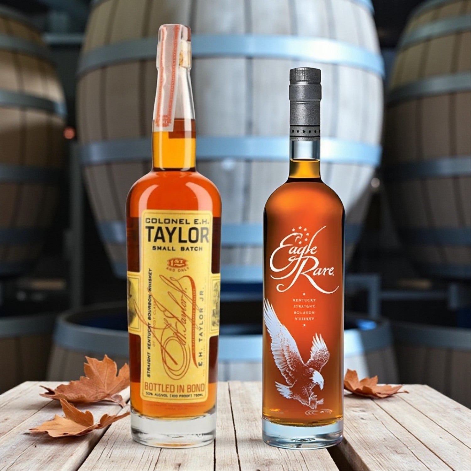 Eagle Rare and Colonel E.H. Taylor Small Batch Bourbon bottles on wooden table with bourbon barrels and autumn leaves – lifestyle shot from Total Bourbon